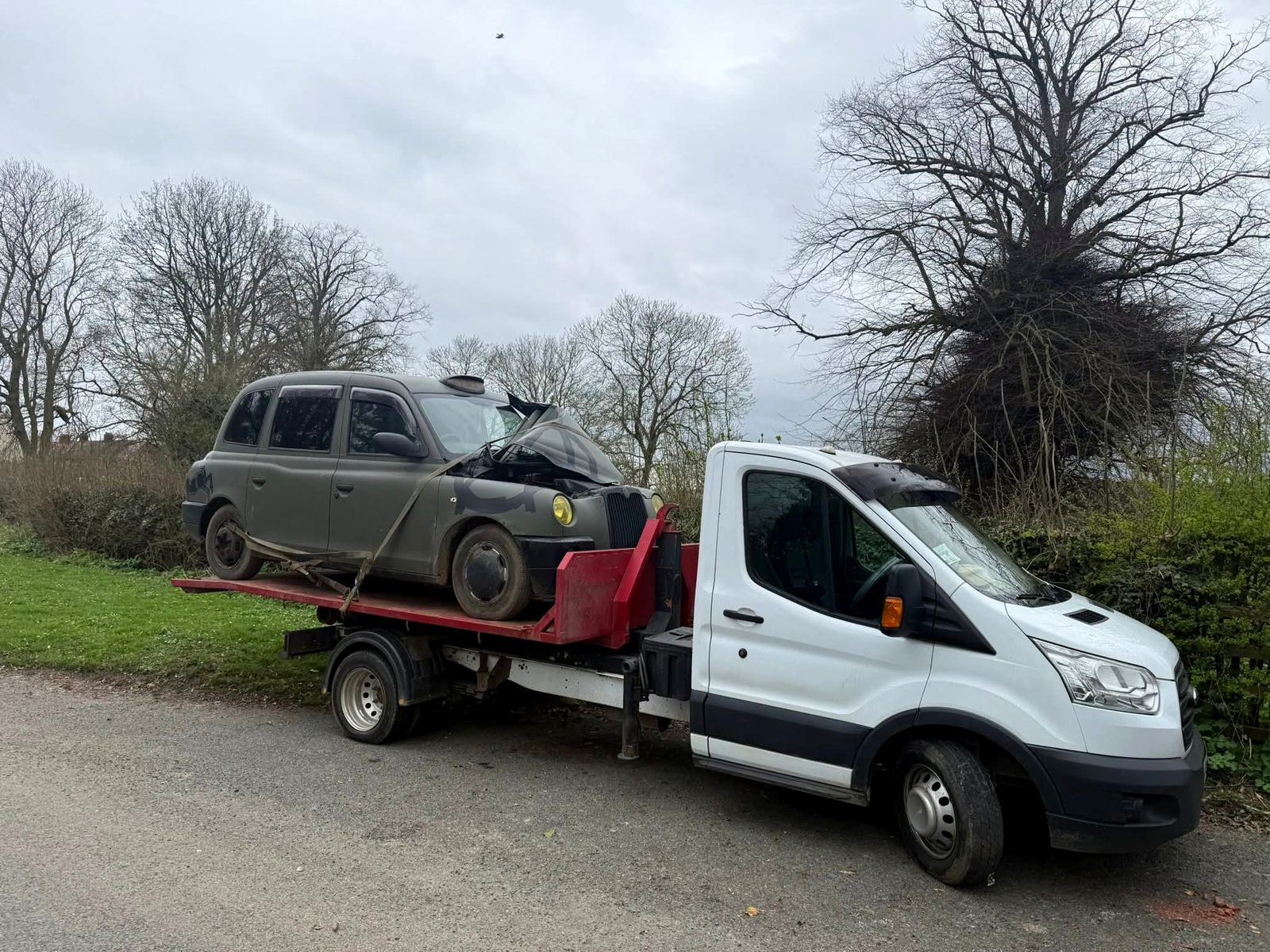 Recovery truck carrying a scrap car