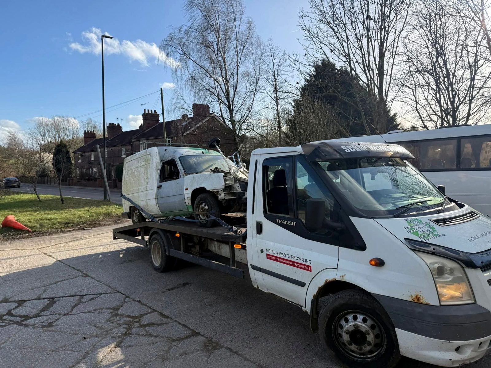 Damaged van loaded on recovery truck